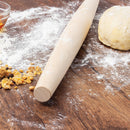 Rolling pin on a wooden surface with flour and dough