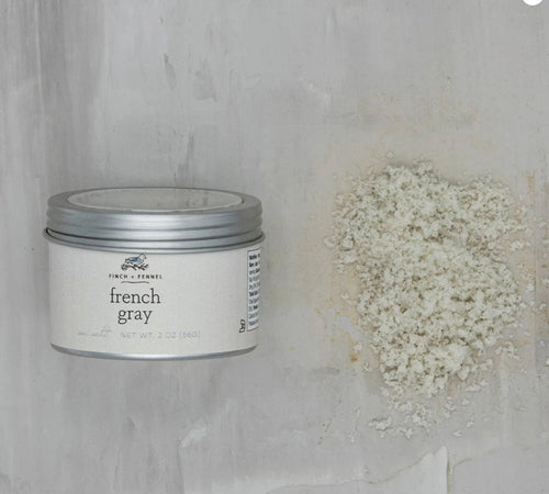 Jar of 'French Gray' sea salt on a textured gray background