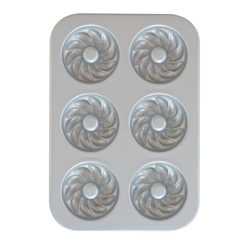 A French twist donut pan with a nonstick silver interior on a white background.