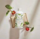 Bottle of Fresh-Cut Basil surface scrub with basil leaves and tomatoes on a light background