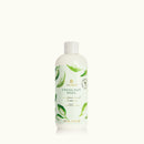 Bottle of Thymes Fresh-Cut Basil surface scrub on a white background