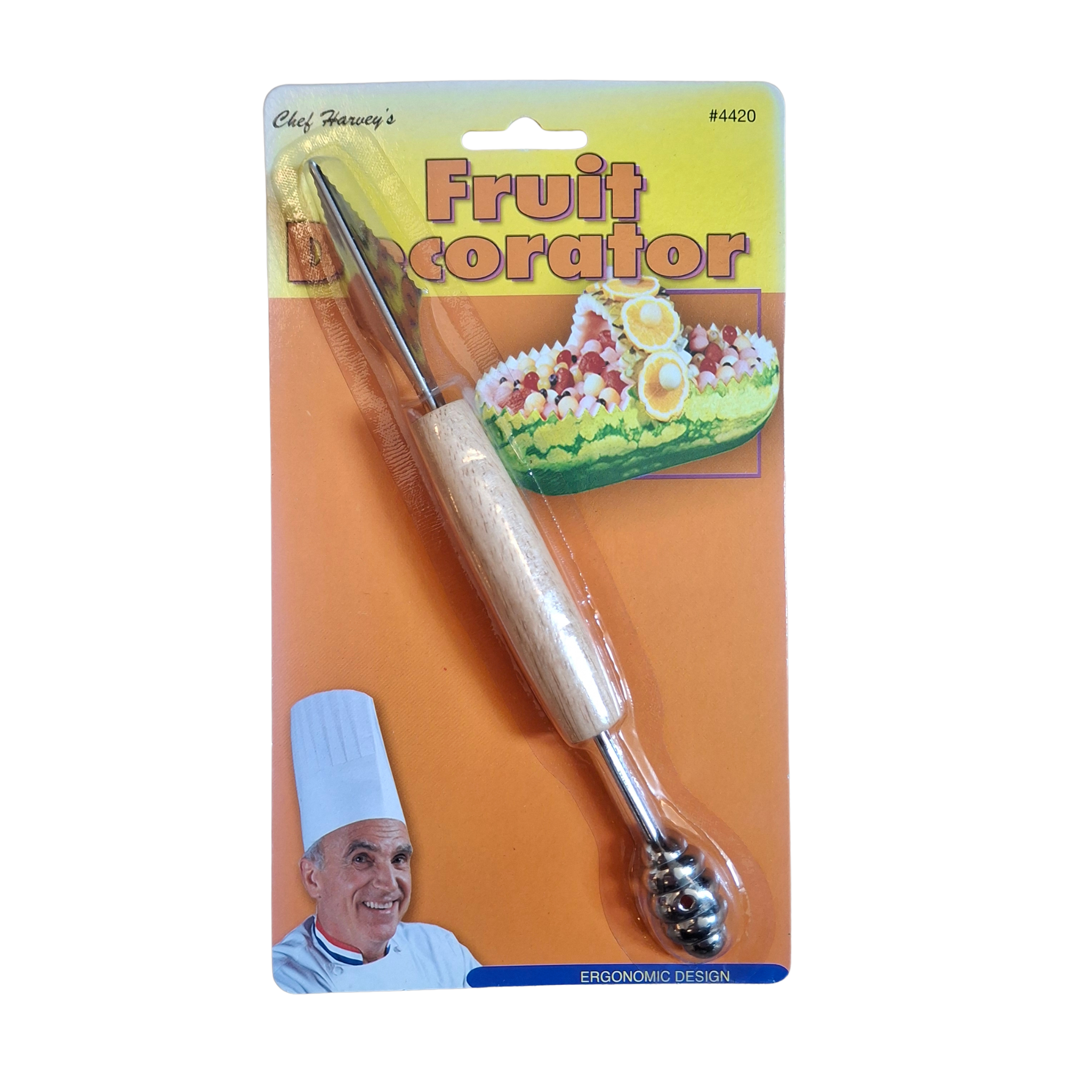 A fruit decorator tool with a light wood handle and metal ball tip, attached to a yellow and orange retail card labeled 'Fruit Decorator' with a chef illustration.
