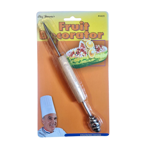 A fruit decorator tool with a light wood handle and metal ball tip, attached to a yellow and orange retail card labeled 'Fruit Decorator' with a chef illustration.