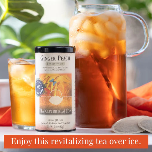 Ginger Peach iced tea with a canister of The Republic of Tea Ginger Peach tea on a table.