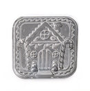 Metallic gingerbread house-shaped cookie stamp on a white background