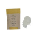 A package of Finch & Fennel Gluten-Free Ancient Grain Gluten-Free Pancake + Waffle Mix next to a small pile of the mix itself on a white background.