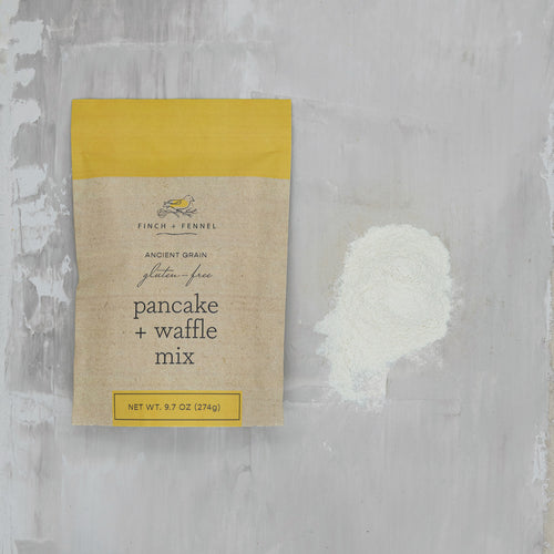 Packaging of Finch + Fennel pancake and waffle mix on a textured gray background