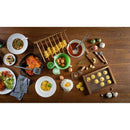 Wooden table with various food items and kitchen utensils on a white background