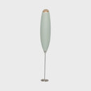 Portable milk frother on a white background.