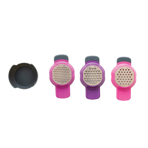 Three stainless steel and plastic graters with pink and purple handles, displayed alongside a black holder.