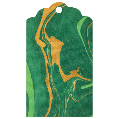 A photo showing a marbled tag with green and gold patterns.