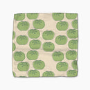 Beige towel with green tomato pattern on a white background