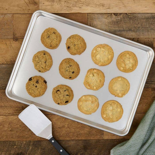 Baking tray with cookies on a wooden surface
