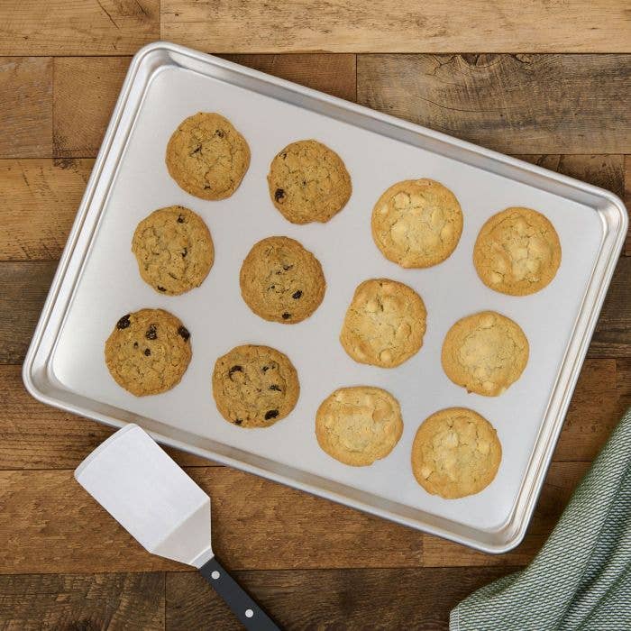 Baking tray with cookies on a wooden surface