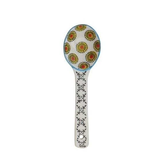 A hand painted ceramic spoon on a white background.