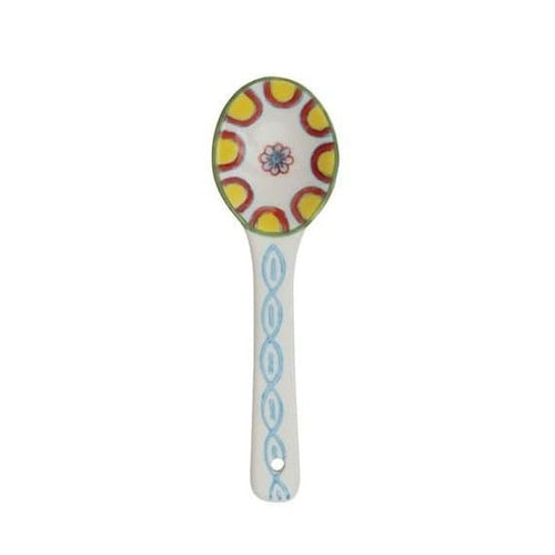 A hand painted ceramic spoon on a white background.