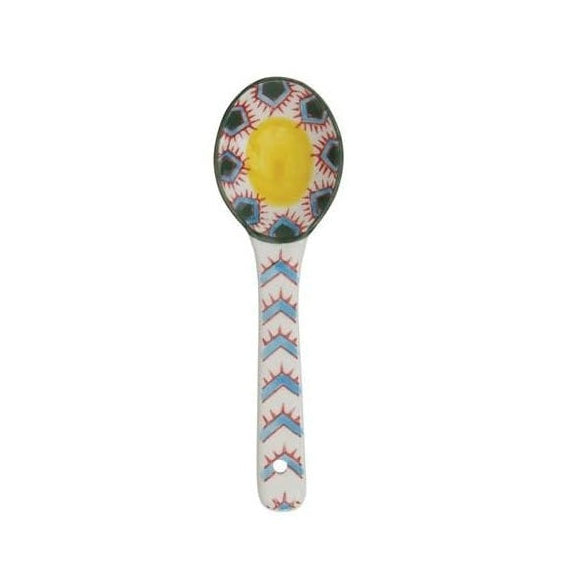 A hand painted ceramic spoon on a white background.