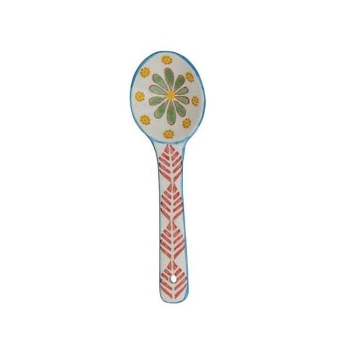 A hand painted ceramic spoon on a white background.