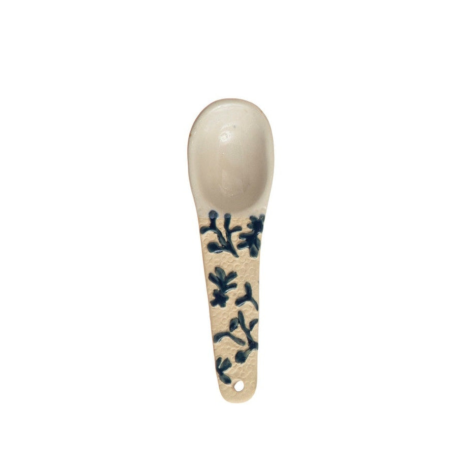 A hand-painted spoon with floral pattern on the handle.