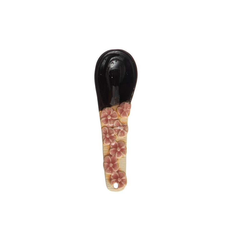 A hand-painted spoon with floral pattern on the handle.