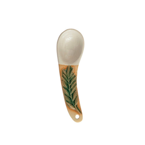 A hand-painted spoon with floral pattern on the handle.