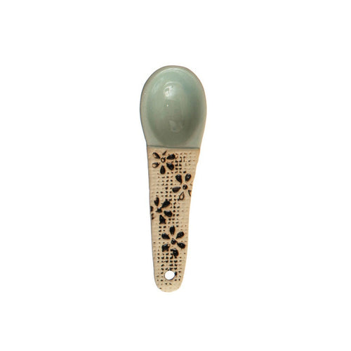 A hand-painted spoon with floral pattern on the handle.
