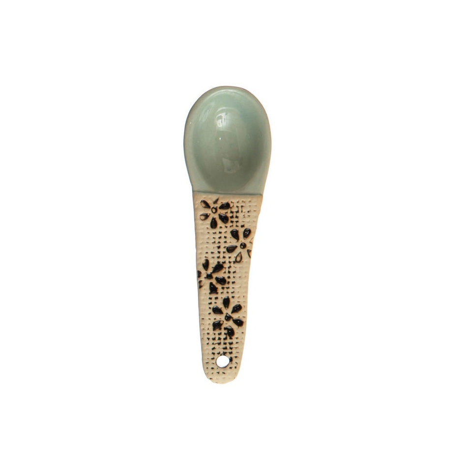 A hand-painted spoon with floral pattern on the handle.