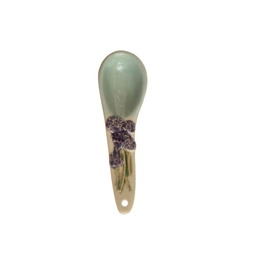 A hand-painted spoon with floral pattern on the handle.