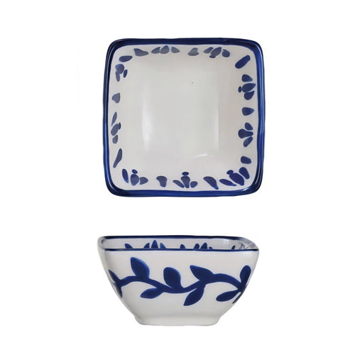 Ceramic bowl with blue vine patterns on a white background