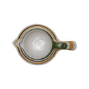 Set of four ceramic measuring cups with green handles on a white background