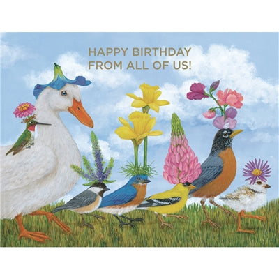 A colorful birthday card featuring a whimsical illustration of various birds with flower nests on their heads, set against a blue sky background. The card has a 'Happy Birthday' message and includes an off-white envelope.