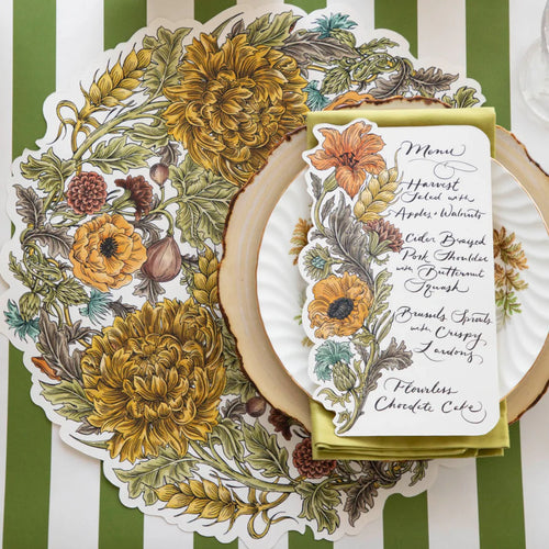 Decorative table setting with floral menu card on a striped tablecloth
