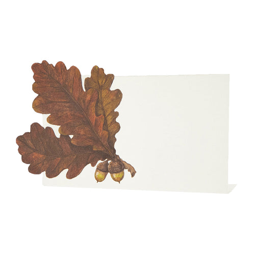 Decorative leaf and acorn place card design on a white background