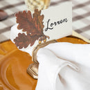 Place card with leaf design and 'Lorren' text on a table setting.