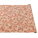 A rolled out paper table runner with a cherry blossom floral pattern on a beige background.
