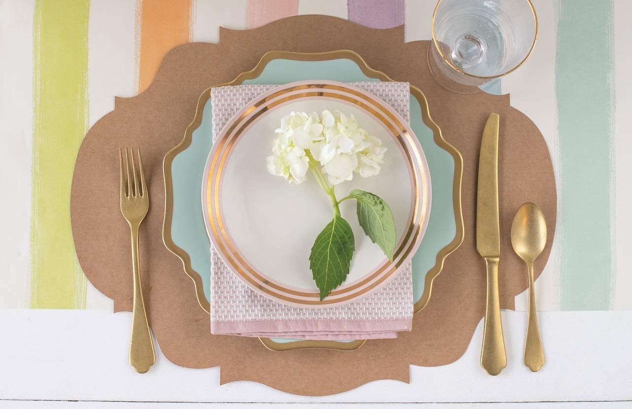 A French frame placemat with plate, flatware, napkin, and salad plate on top, decorated with a flower in the center.