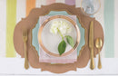A French frame placemat with plate, flatware, napkin, and salad plate on top, decorated with a flower in the center.