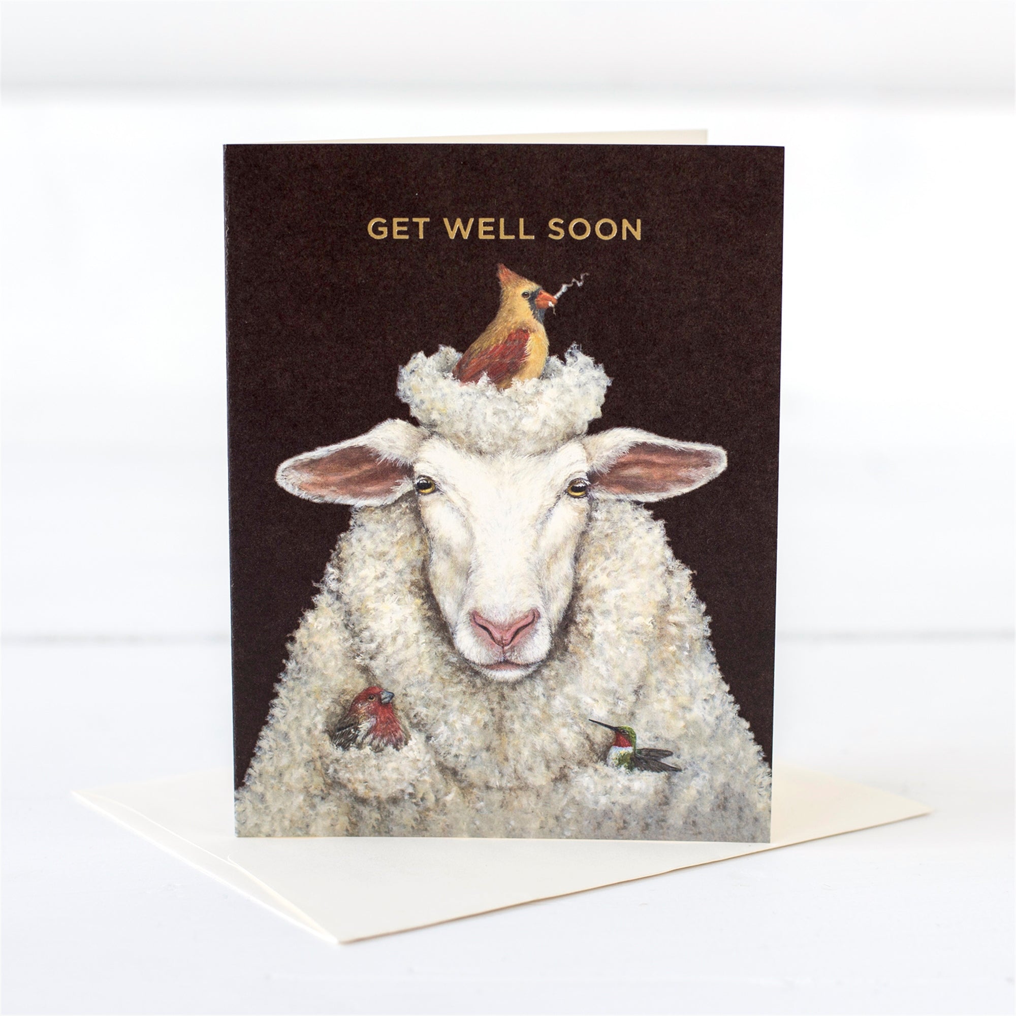 A get well soon card featuring an illustration of a sheep with a female cardinal, grossbeak, and hummingbird nesting in its wool on a white background.