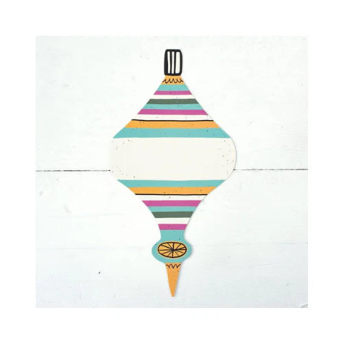 A colorful striped table accent in the shape of a Christmas ornament.