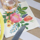Floral-patterned napkin with a glass and knife on a table
