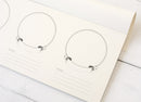 Set of tasting papers on a white surface.