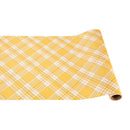 A rolled out yellow plaid table runner with a checkered pattern.