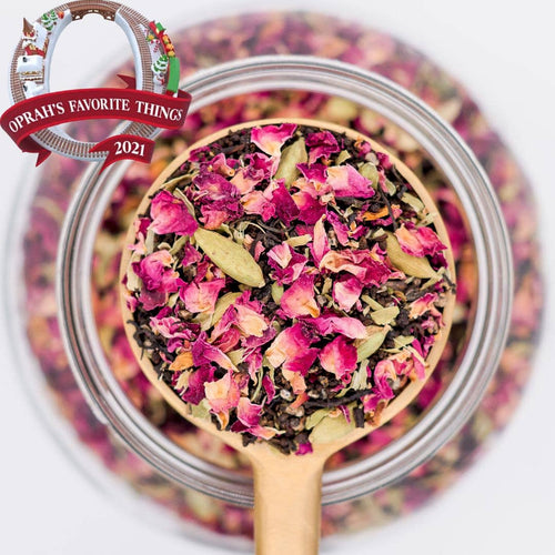 Tea leaves with pink and green hues on a wooden spoon, with 'Oprah's Favorite Things 2021' label.