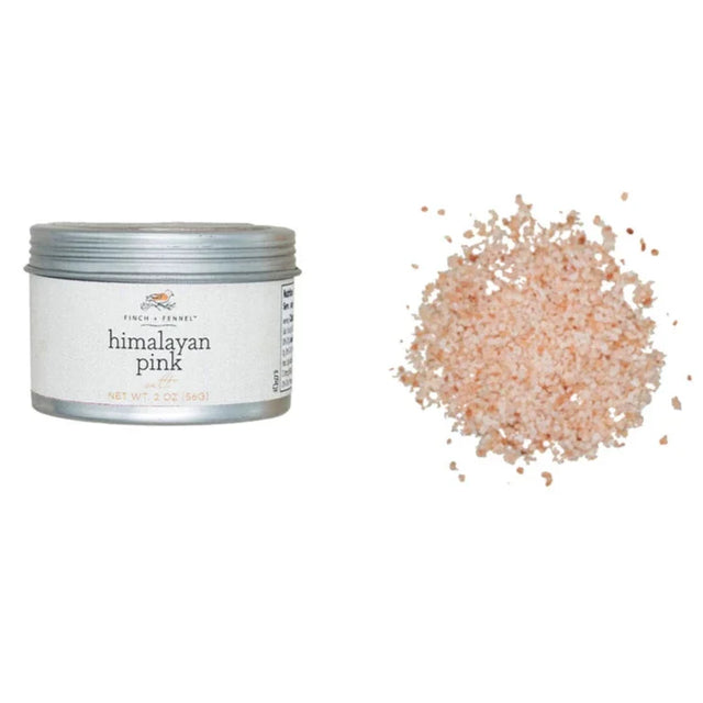 Himalayan pink salt container with a small pile of salt on a white background