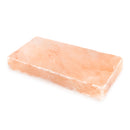A pink Himalayan salt block on a white background.