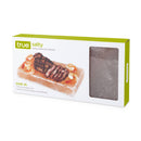 Packaging for a Himalayan salt block with white and green accents and an open window to see the salt block, and an image of a salt block with steak and shrimp on it.