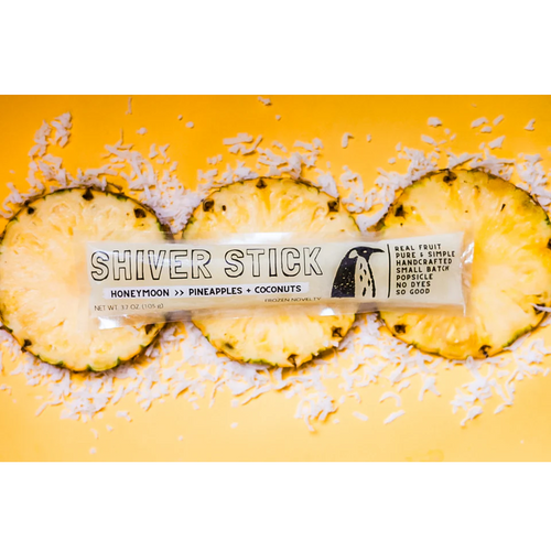 Shiver Stick bar with pineapple slices and coconut shreds on a yellow background