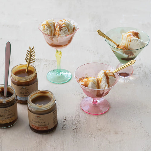 Ice cream dishes with caramel sauce on a light surface