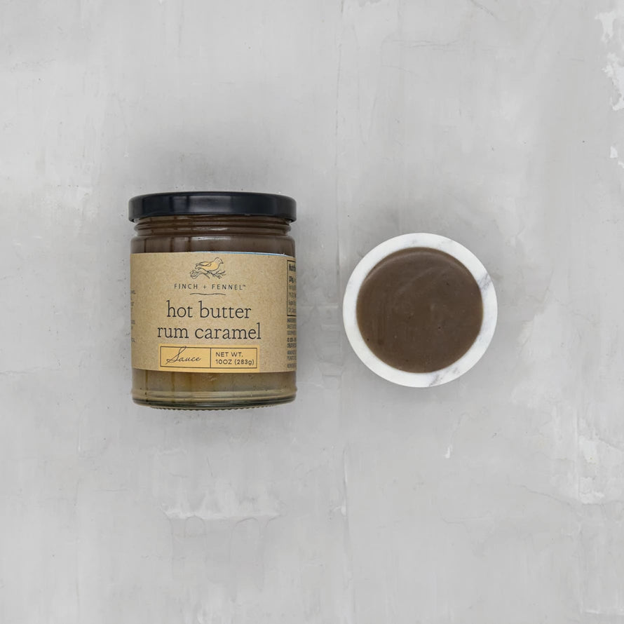 Jar of 'Hot Butter Rum Caramel' on a gray background