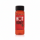 Bottle of hot honey with a red label and black cap on a white background